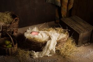 33002953 - baby doll acting as jesus in a christmas nativity scene